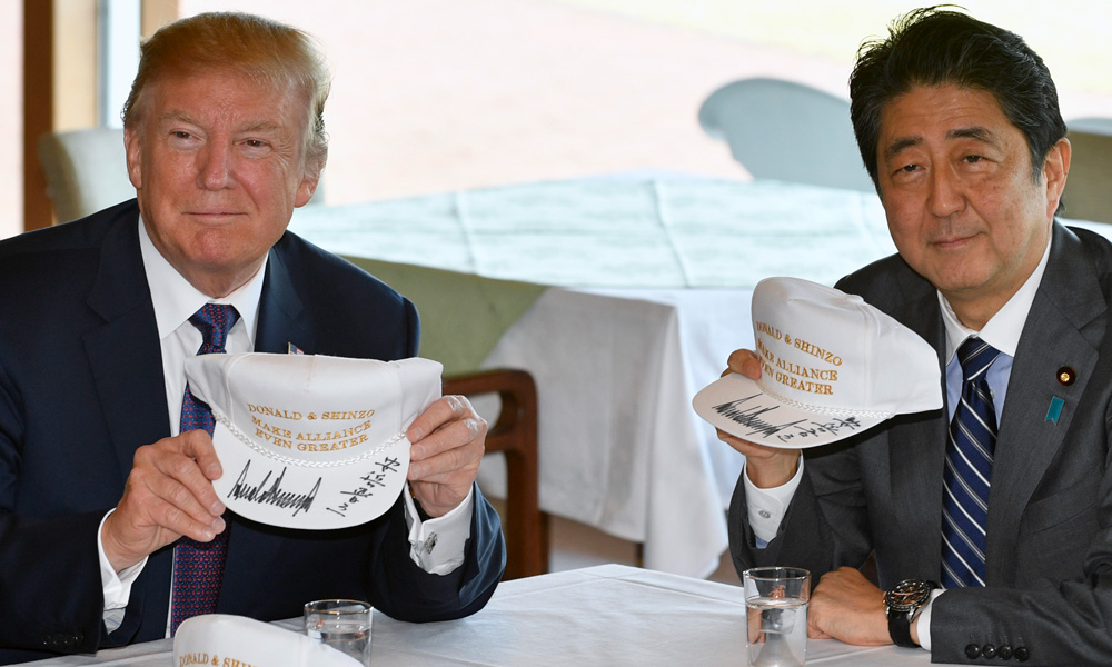 Trump, Abe conduct diplomacy over golf and sumo