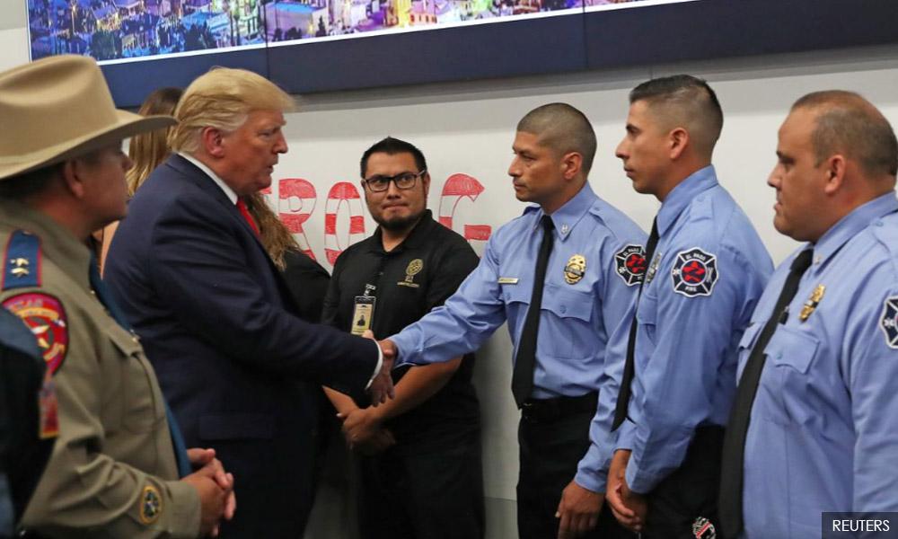 Trump visits mass shooting victims, protesters shout 'Do something!'