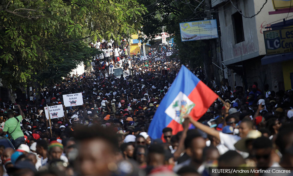 Singing and dancing, Haitians flock to streets in anti-government protest