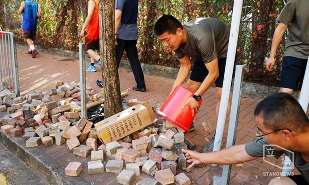 China's PLA soldiers helping clean up streets after Hong Kong protests